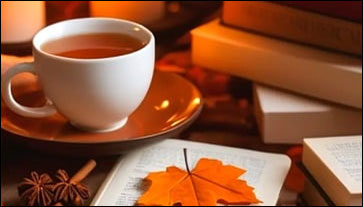 cup of tea, books, orange maple leaf